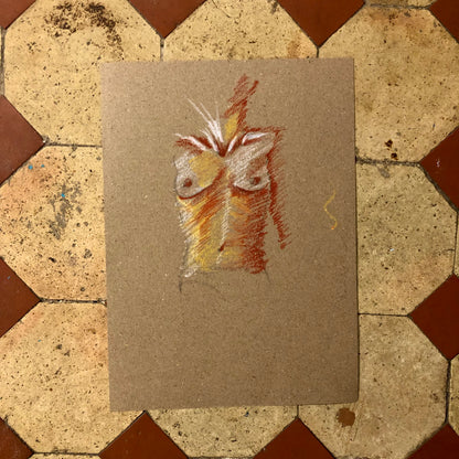 A drawing of a woman’s torso on a piece of paper, placed on a tiled surface.